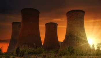 cooling towers in nuclear power plant at sunset