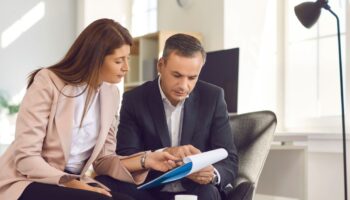 Man and woman looking at pad of paper
