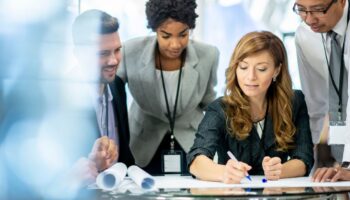 Group of people looking over a business plan on a desk
