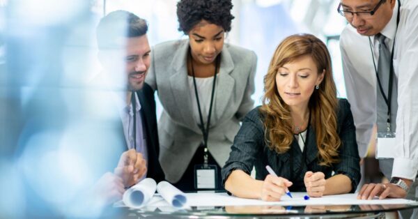 Group of people looking over a business plan on a desk