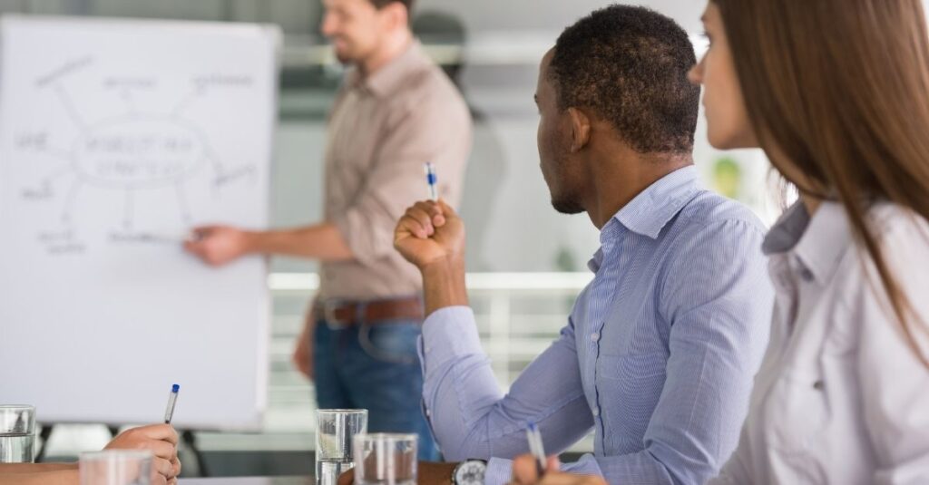 People looking at big notepad in brainstorming meeting