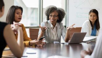 People discussing business around a conference table