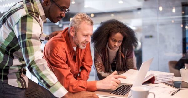 Group of people looking at a computer