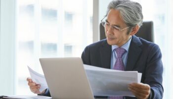 Business man at desk reading documents