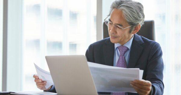 Business man at desk reading documents