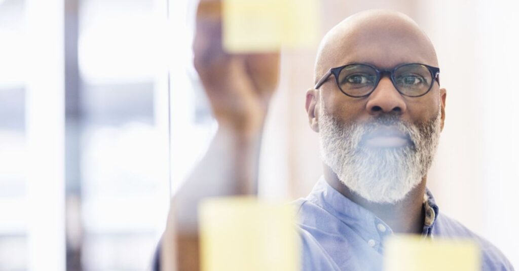 Man writing on sticky notes