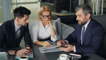 3 executives discussing an issue