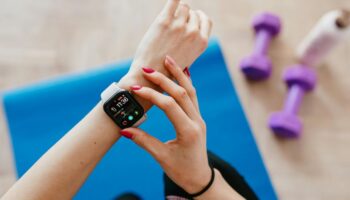 Woman adjusting her smart watch while working out
