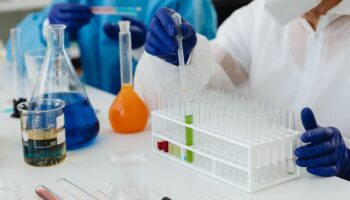 Person filling pipettes in a lab