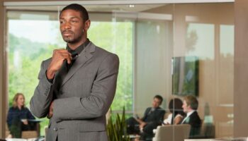 An executive standing outside of a conference room