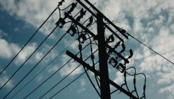 utility pole against a blue sky with clouds