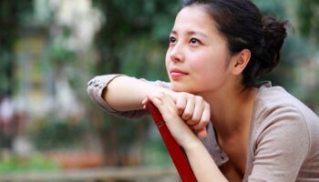 Woman daydreaming in a chair