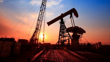 Oil field against a sunset