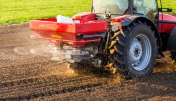Tractor spreading fertilizer