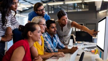 Innovation team using AI on a laptop